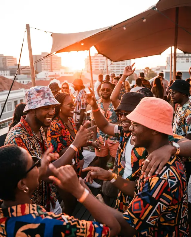 Friends dancing on a rooftop at golden hour (illustrative image, fictional event)